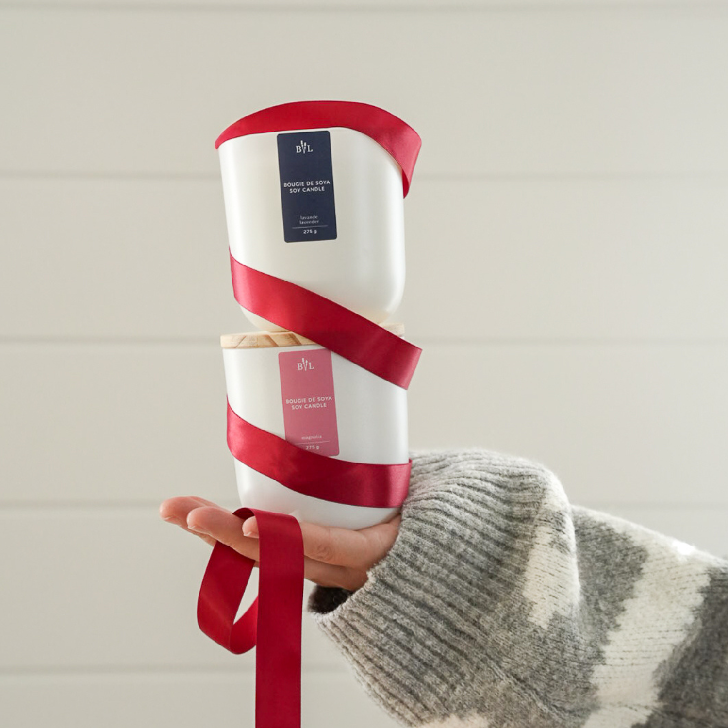 Bougies de soya lavande et lavande-magnolia enroulées d'un ruban rouge